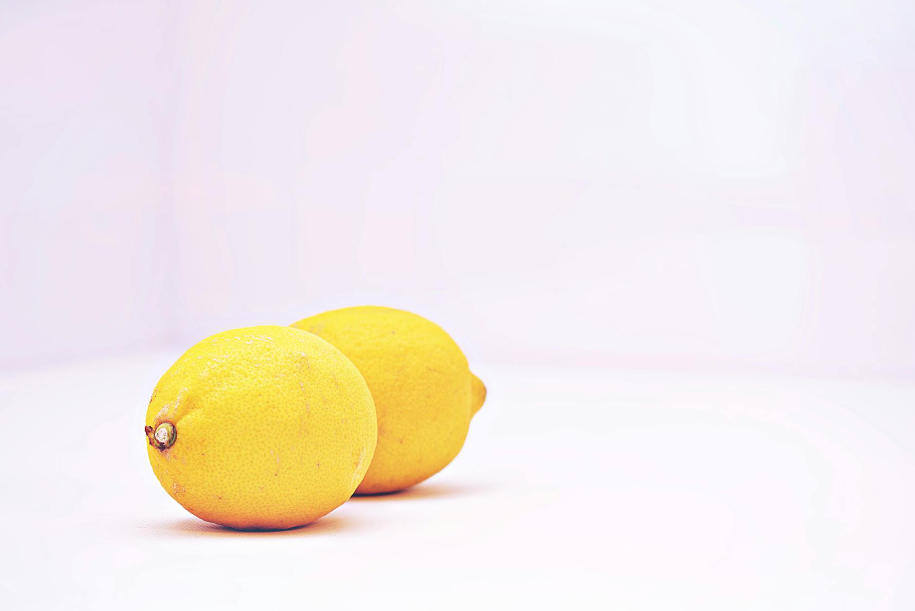 Fresh lemons stacked beside books, symbolizing openness and shared learning in intimate partnerships