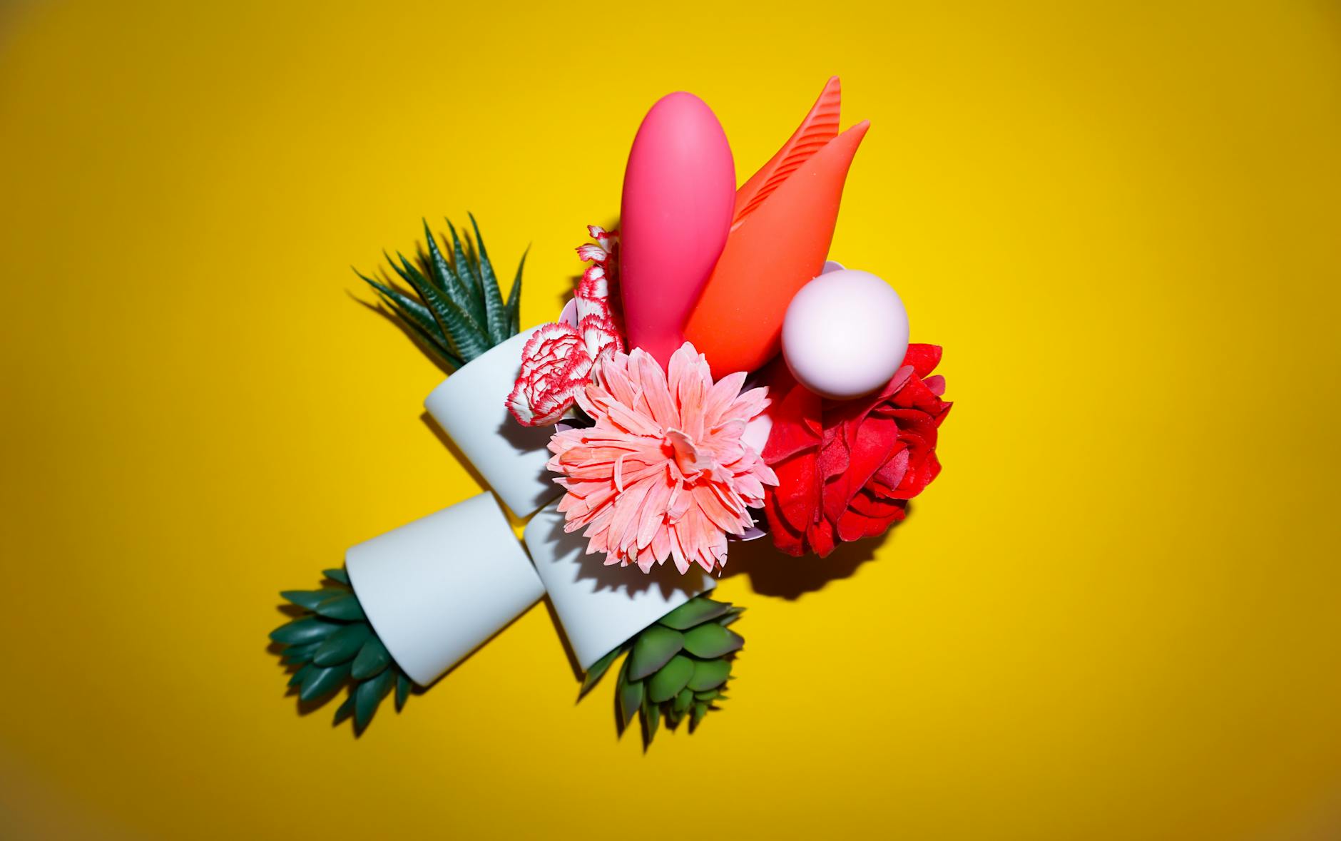 Two people holding lemon vibrators together in conversation, exploring pleasure as a couple