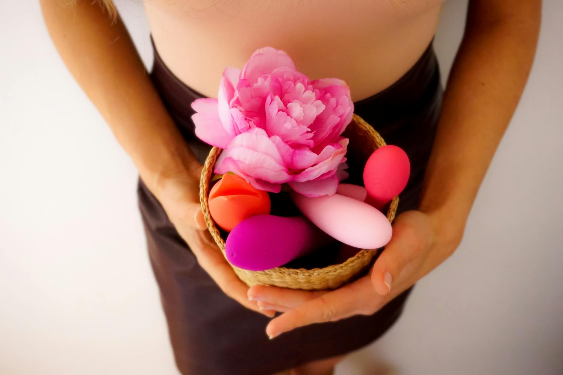 Pink vibrator on a purple background with heart confetti and candles